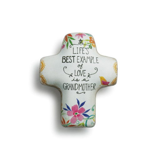 Lifes best example of love is a grandmother' printed on white cross figurine with flower prints