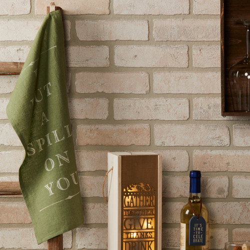 green kitchen towel hanging on hook next to wine bottle box and wine bottle