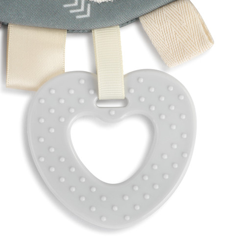 cream colored ribbon loop holding gray rubber heart with bumps on it