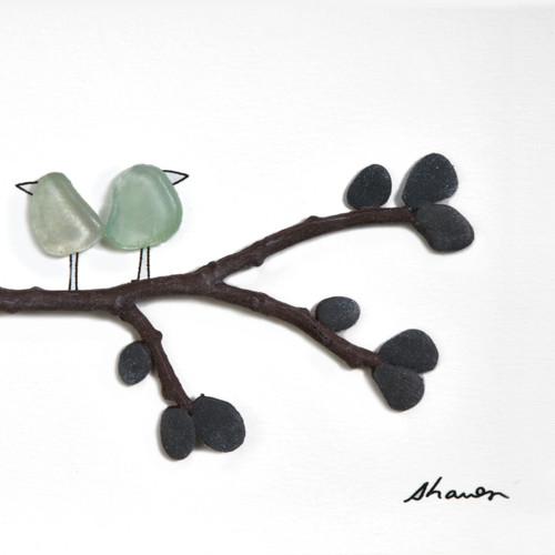Close view of white background with brown tree branch and two light blue pebble birds on it
