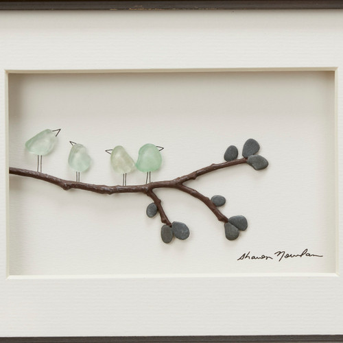 Close view of pebble branch and light blue birds against white photo background