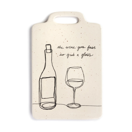 An off-white serving board with black specks, a drawn bottle of wine and filled wine glass, and a message in black script that reads the wine goes fast so grab a glass"."