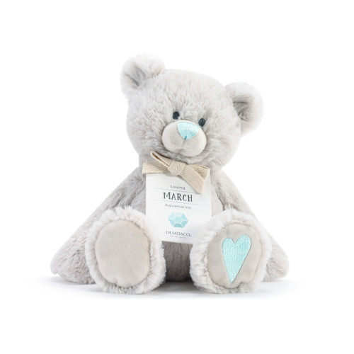 A fluffy white plush bear with a light blue nose, light blue heart, and a white product tag that reads "Loving March".