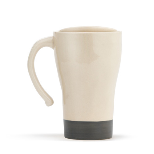 The backside of a tapered, cream, ceramic travel coffee mug, with a thick gray stripe base, a single gray heart in the center, and reads dog mom" in a gray typewriter font. With a handle, and lid placed on top."