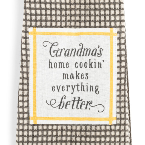A close up image of a white and yellow patch with a message about Grandma's on a kitchen boa.