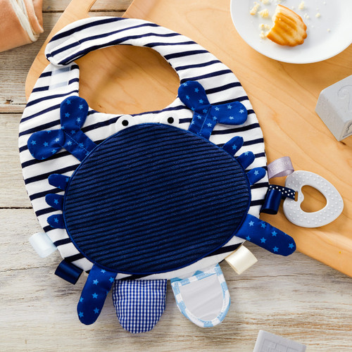 blue bib with crab decal with multipatterned pull tabs
