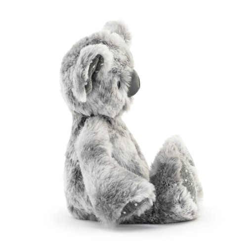 A side profile of a plush, soft, light gray Koala Rattle with dark gray and white polka dotted paws and ears.