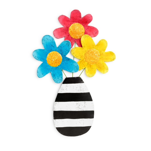 A black and white striped vase door hagner, with three flowers - yellow, blue, and red. Each with gold glitter centers.