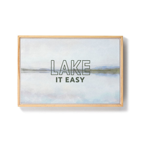 A framed image of a painted lake scene with the saying "Lake It Easy".