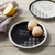black and white plate reading Thank You with macaroons on top