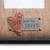 copper heart on top of silver metal square with Love and be Loved etched into it
