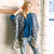 Front view of blonde woman in jeans, blue top, and cream/navy print shawl