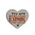 silver heart with gold detailing reading You are Loved