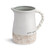 white ceramic mug reading 'gather together' with pointed indent in rim for pouring, handle, tan detaining around base