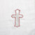 Close view of light pink cross printed on white surface