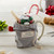 mug with gray drawstring bag reading Merry Christmas with plastic bag inside holding M&Ms