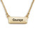 Gold necklace holds a rectangular charm with engraved black lettering