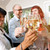 Clear wine glasses with 'celebrate' in gold - images of people holding them in the back