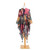 pink silky poncho with multicolor flower designs and tassels on hem on a mannequin