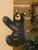 Close view of black bear figurine climbing on wall