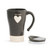 A tapered, charcoal, ceramic travel coffee mug, with a thick cream stripe base, a single cream heart in the center, and reads cat mom" in a cream typewriter font. With a handle, and lid placed to the right of the mug."