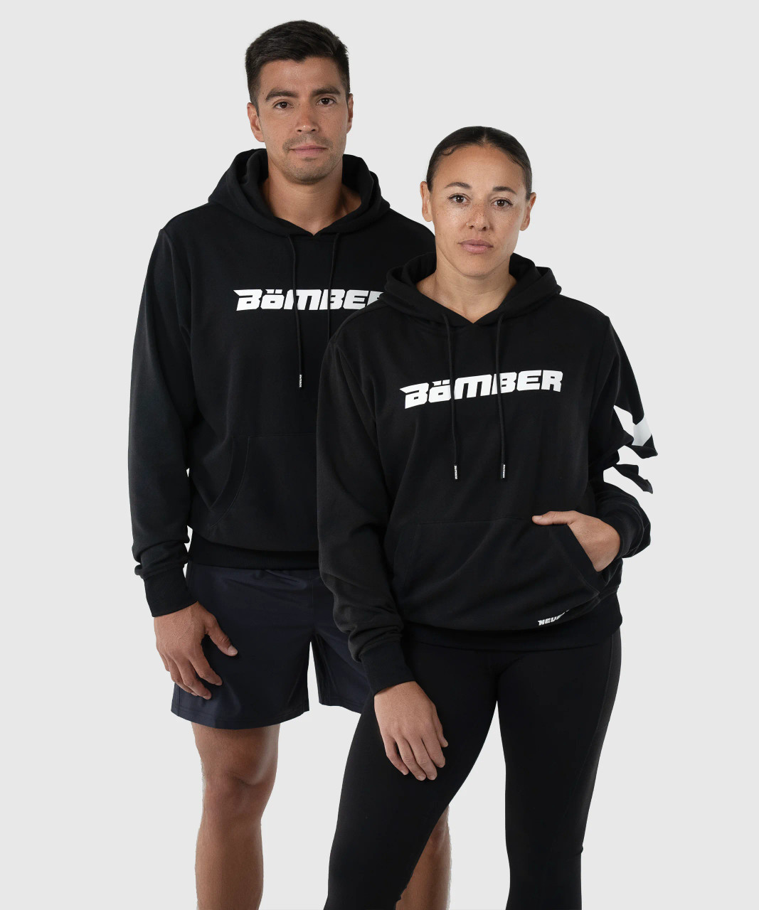 Men’s and women’s black performance hoodies with soft stretch fabric