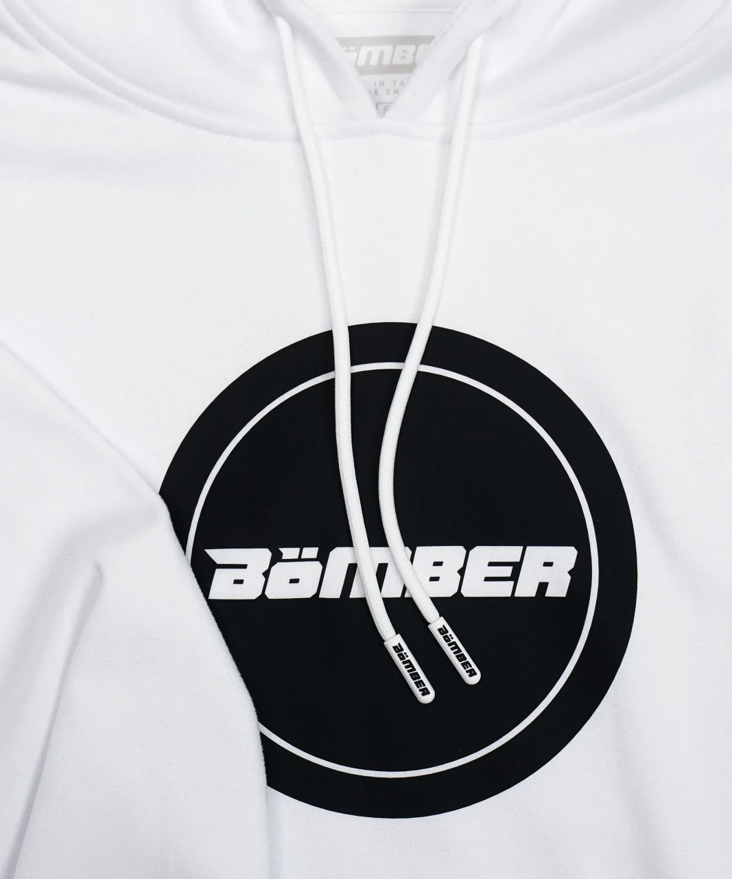 Blaze Hoodie white chest logo detail, close-up view