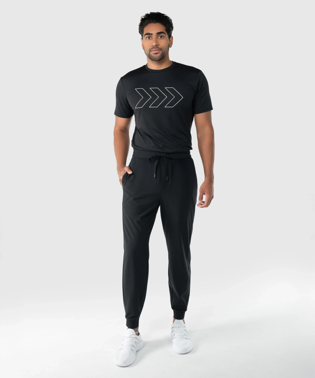 Model wearing black men’s performance joggers with tapered fit