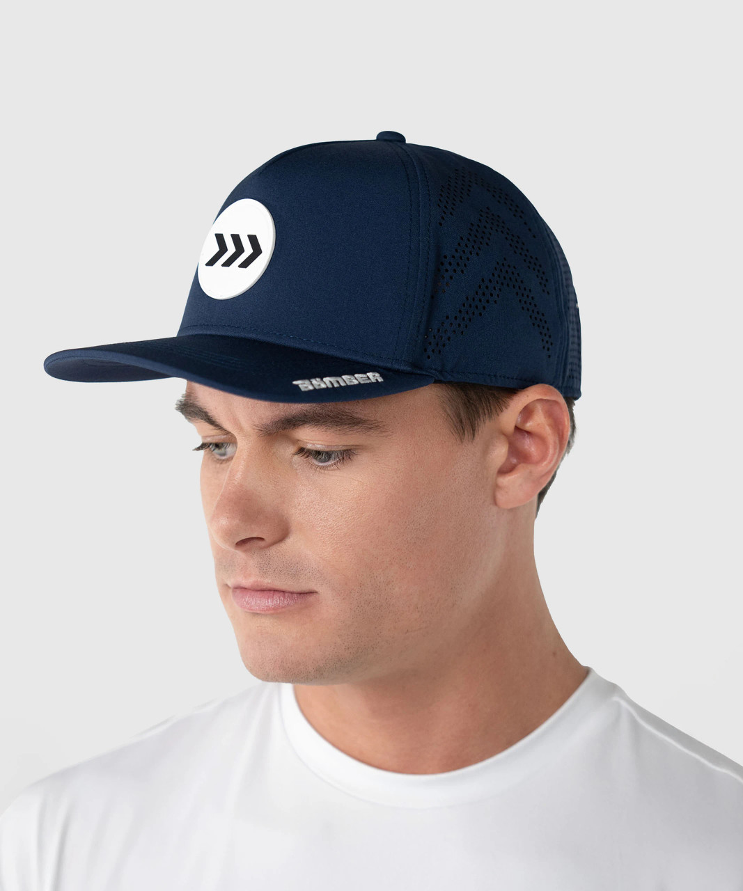 Man wearing navy Bomber performance snapback