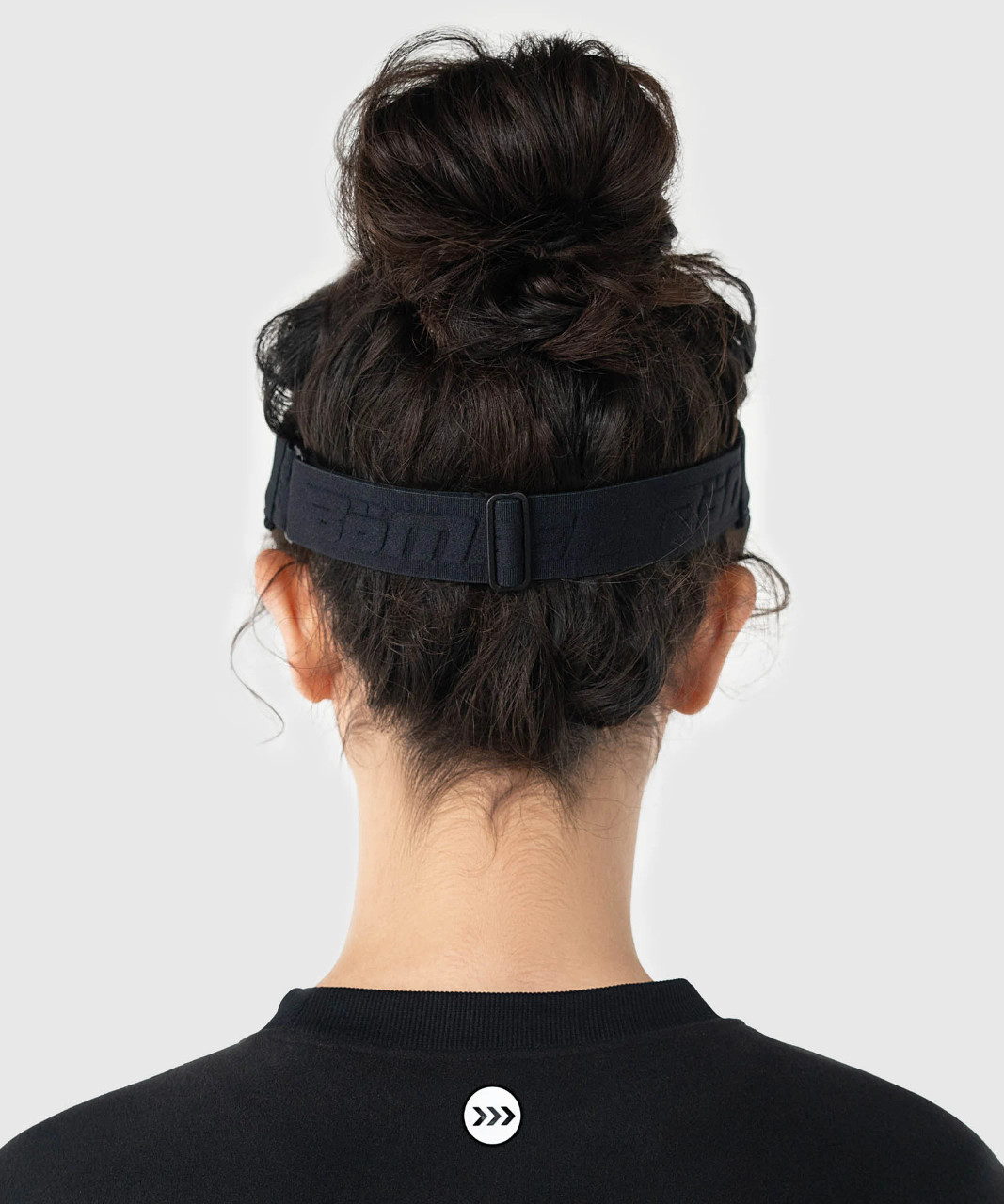 Back view of woman wearing black athletic visor