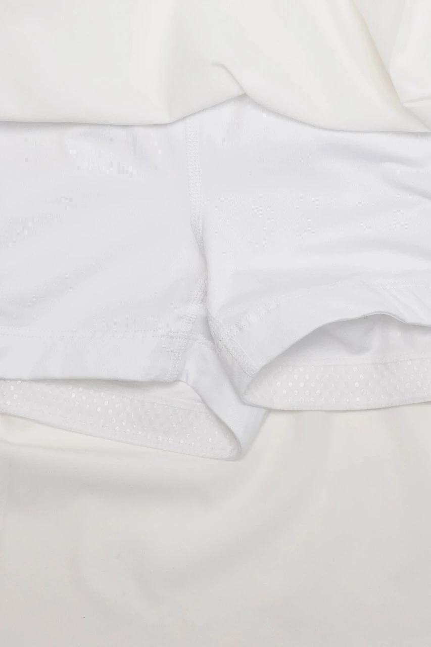 Pursue Skort, white performance skort with built-in shorts, close-up view