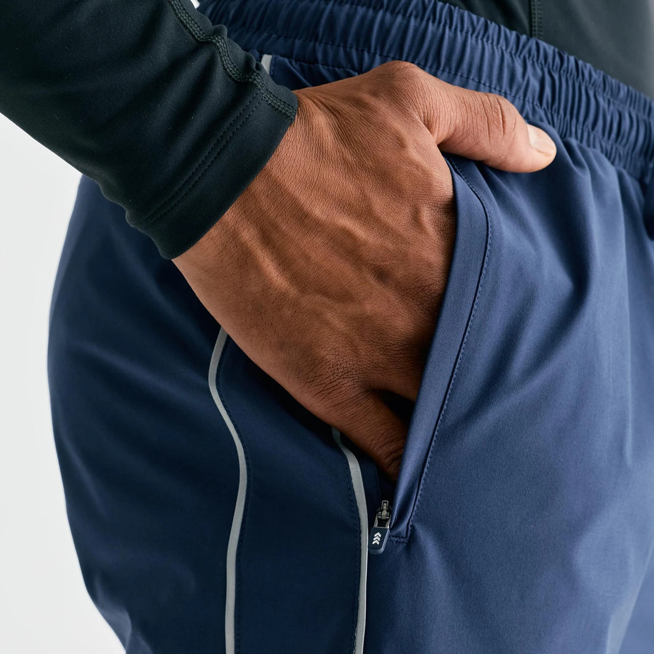 Surpass Pant, men's navy jogger pants, close-up hand-in-pocket detail
