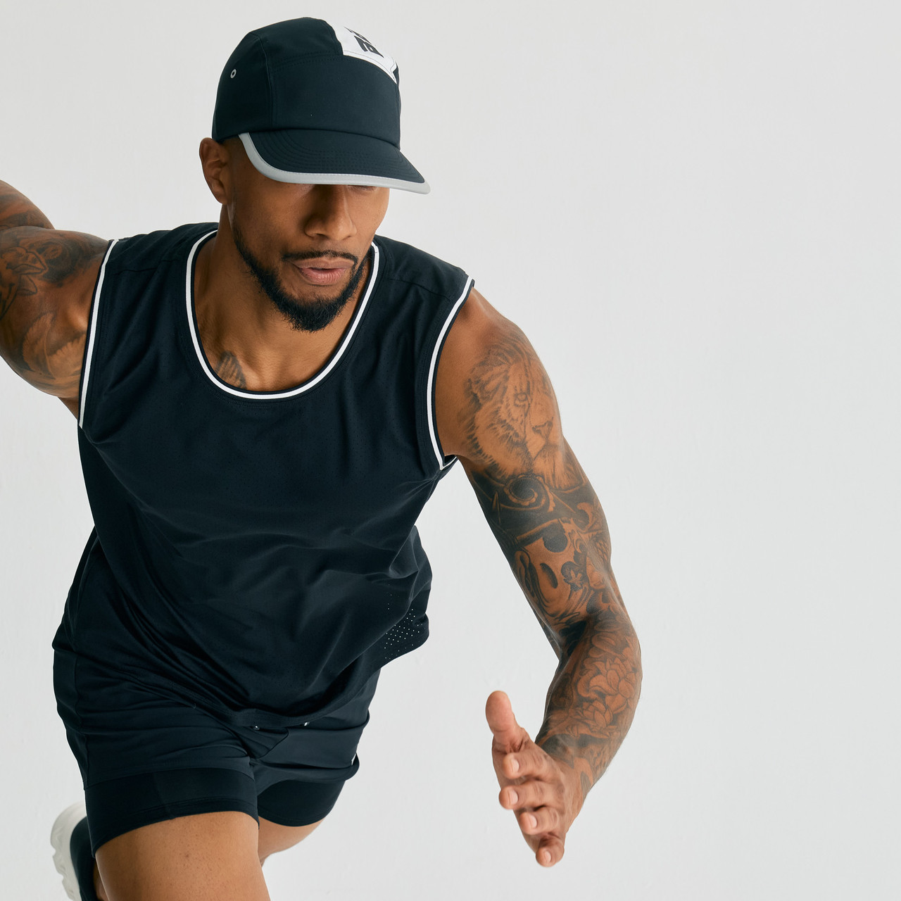 Pivot CC Tank, men's black performance tank with athletic fit, running action shot