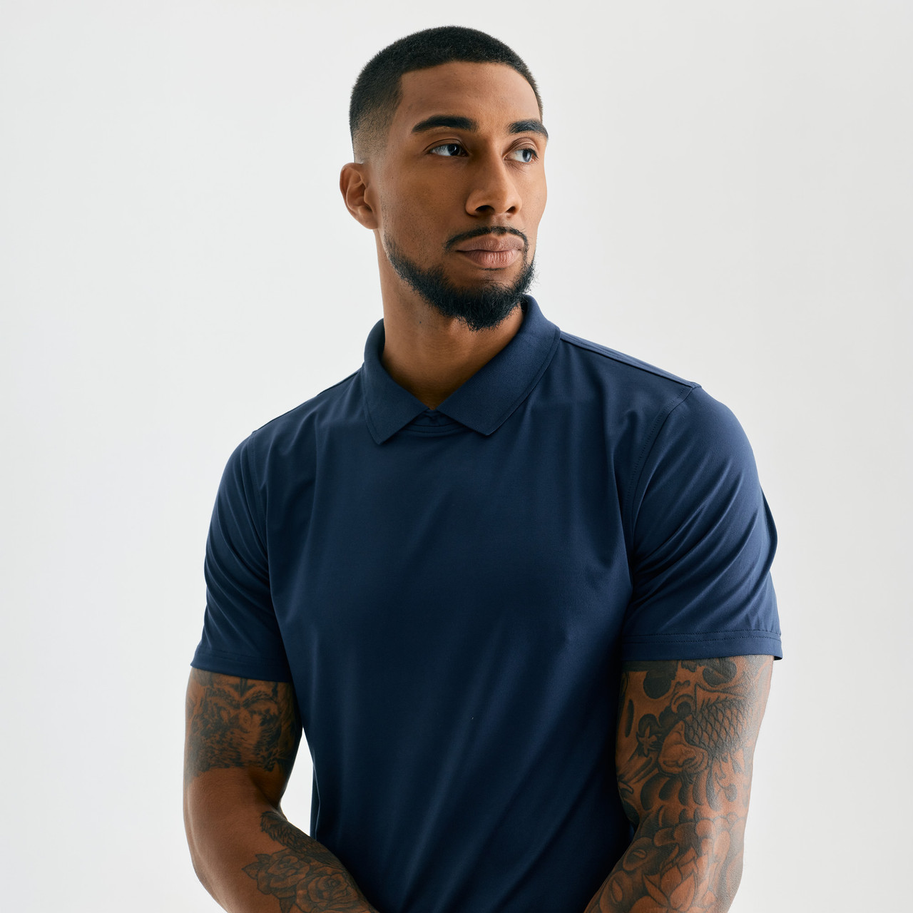 Legacy T-Polo, men's performance navy polo shirt, studio pose