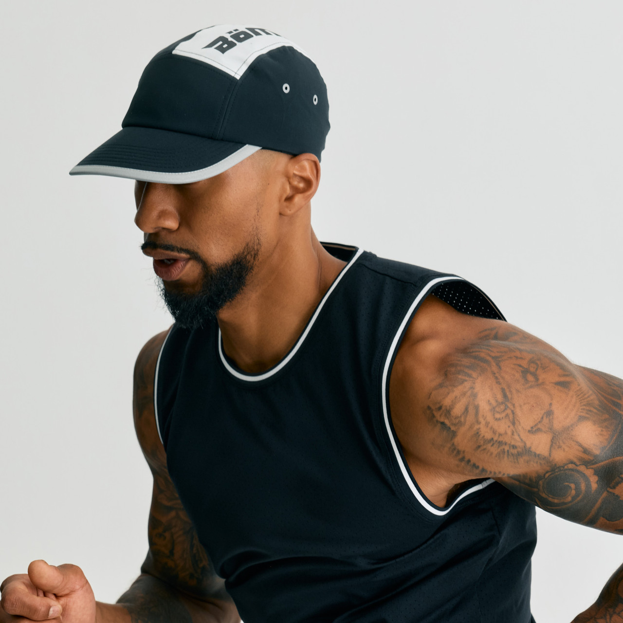 Trek Hat, unisex black and white hat, male model running action shot