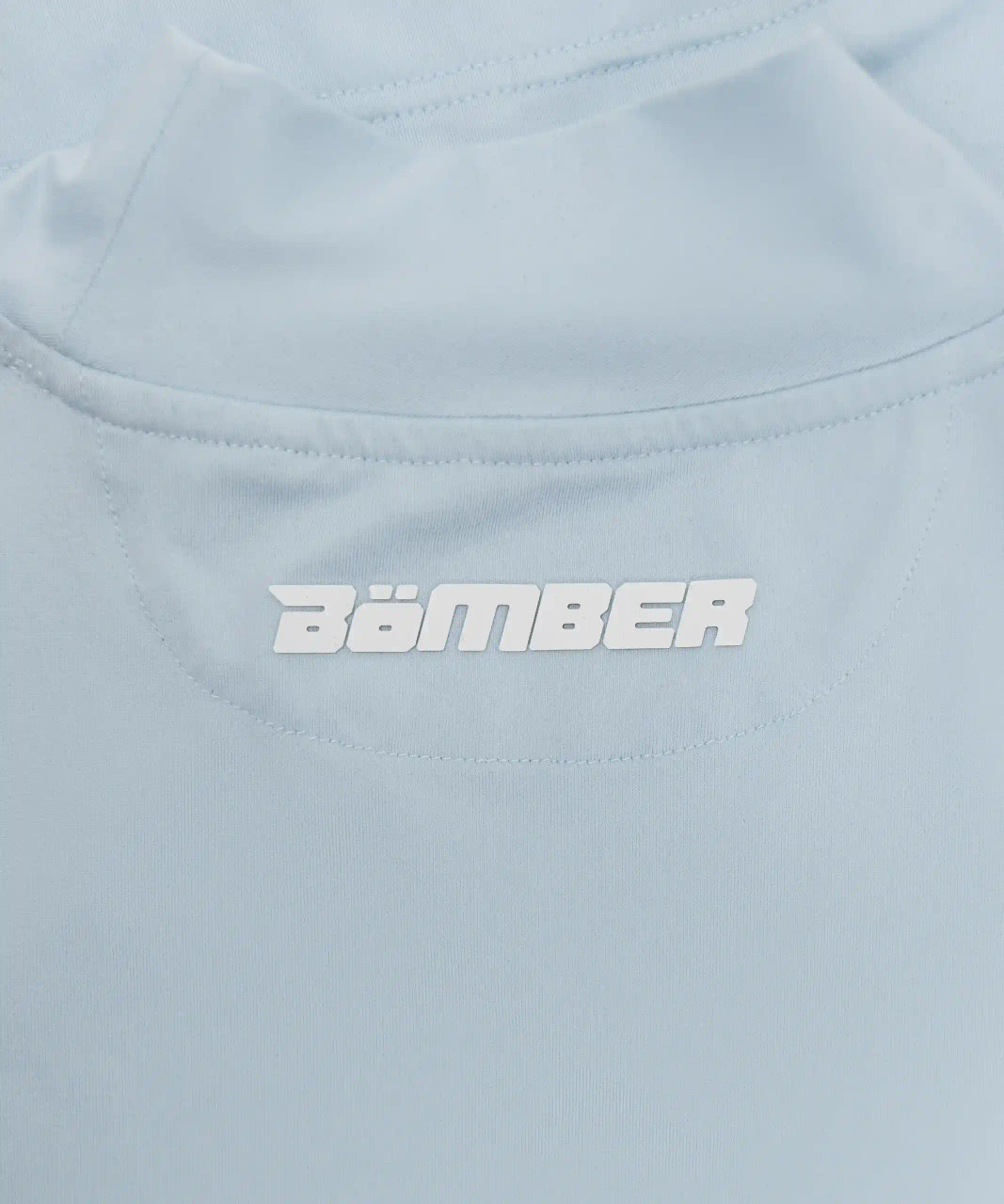 Close-up of logo on light blue performance tank top