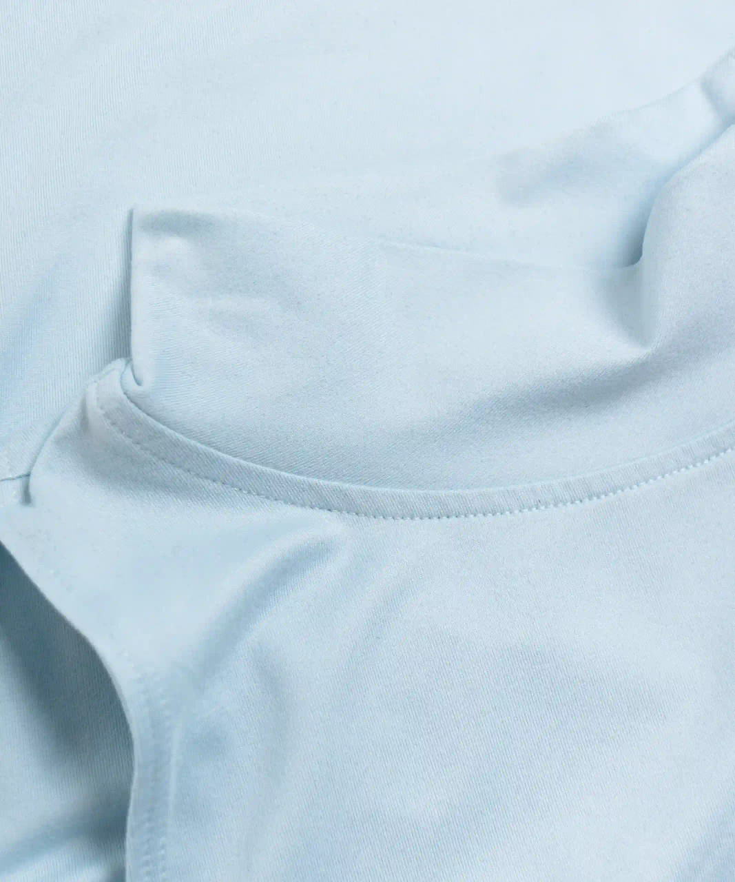 Close-up of breathable performance fabric on athletic tank top in light blue