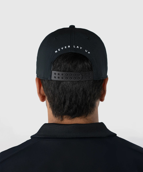Back view of man wearing structured black and white performance snapback hat