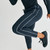 Surpass Pant, men's black jogger pants, close up running action shot