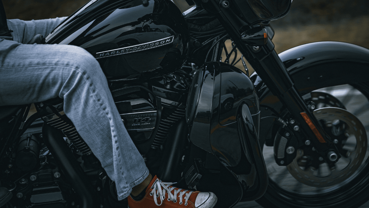 Lower fairing image with a man on a Harley Davidson motorcycle. 