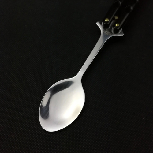 Close-up of Black 440 Steel Balisong Butterfly Spoon stainless steel spoon head with polished finish Close-up of Black 440 Steel Balisong Butterfly Spoon stainless steel spoon head with polished finish