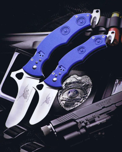 CSSD SC CRMIPT Satin 8Cr13MoV Blue G10 Military Training Knife with two open blades displayed alongside a police shield and handgun in the background
