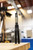 Squid Industries Mako V5 410 Inked Balisong Butterfly Trainer standing open balanced on black-coated handles on a work table Squid Industries Mako V5 410 Inked Balisong Butterfly Trainer standing open balanced on black-coated handles on a work table
