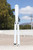 Squid Industries Squiddy White CPVC Balisong Butterfly Trainer open outdoors with trainer blade extended, mountains in the background Squid Industries Squiddy White CPVC Balisong Butterfly Trainer open outdoors with trainer blade extended, mountains in the background