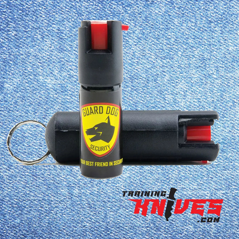 Guard Dog practice pepper spray canister standing upright with a spray bottle laying down behind it
