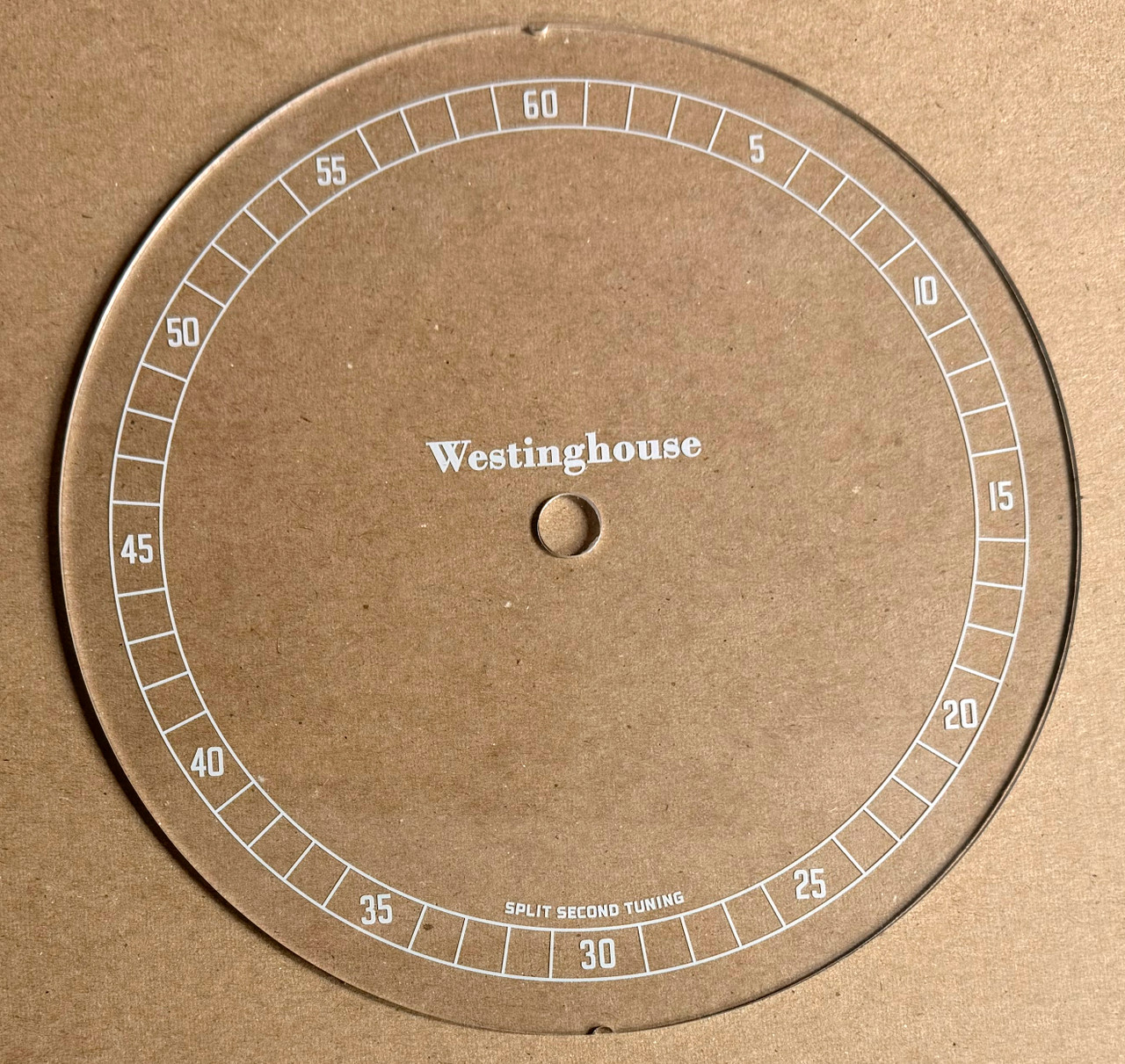 Image taken against a tan/brown background to better illustrate light color portions of dial. The dial is clear other than scale graphics.