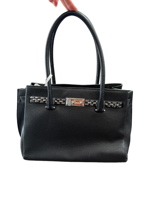 Vist Large View of Product Image Which is Michael Kors black pebbled leather tote bag with dual top handles, silver-tone studded front strap detail, interior zip compartment, and metal feet on the base.