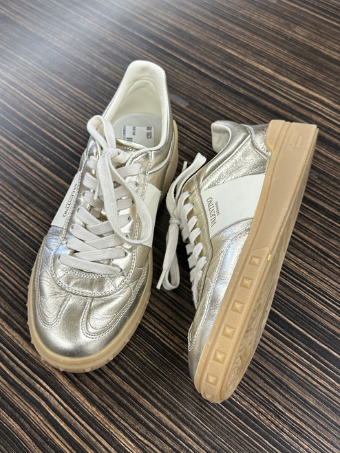 Vist Large View of Product Image Which is These are Valentino Garavani Upvillage metallic gold leather sneakers with a rubber sole