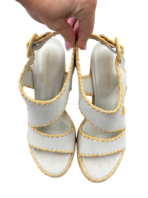 Vist Large View of Product Image Which is Paloma Barceló women’s light gray platform sandals with crisscross straps, tan whipstitch-style trim, ankle straps, and woven raffia-style chunky high heels.