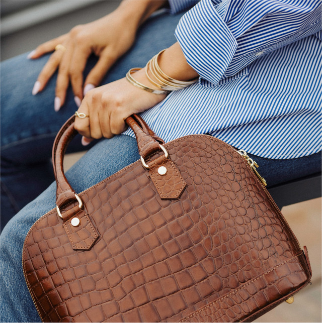 Person holding a designer purse